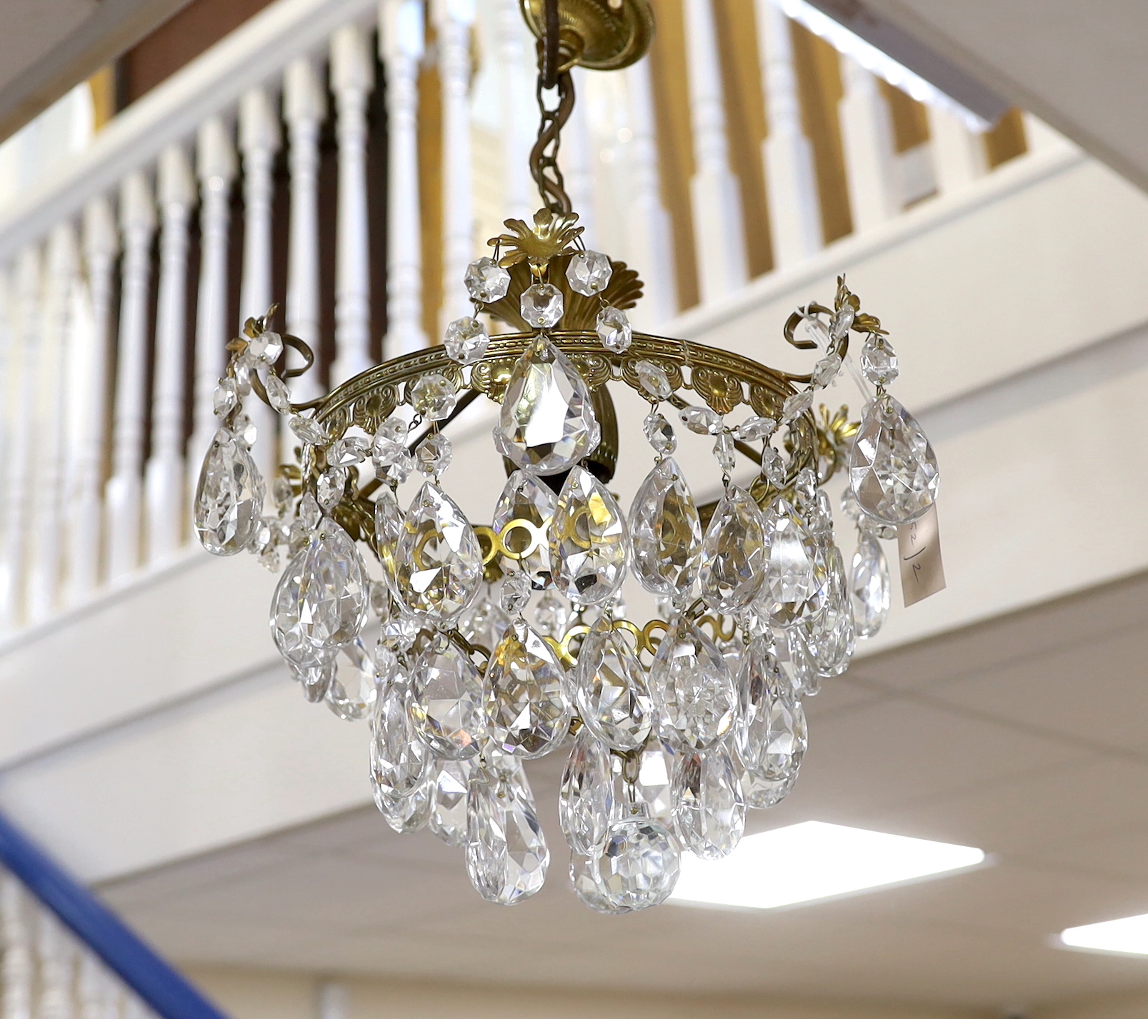 A gilt metal and cut glass ceiling shade hung faceted drops, height 42cm